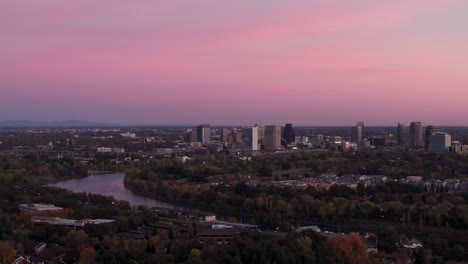 Panning-to-the-right-drone-shot-of-sunset-in-Sacramento,-CA-with-a-colorful-sky