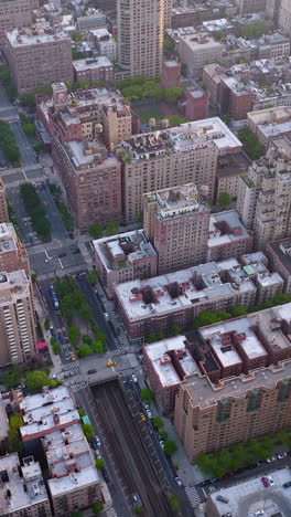 multi-storied buildings of densely-built quarters of metropolis. busy city at daytime. aerial perspective. vertical video