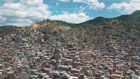 Wide-drone-aerial-landscape-view-of-houses-and-buildings-in-comuna-13-slums,-Medellin,-Colombia