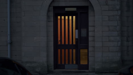 late night shot of metal doors of a building with a code lock