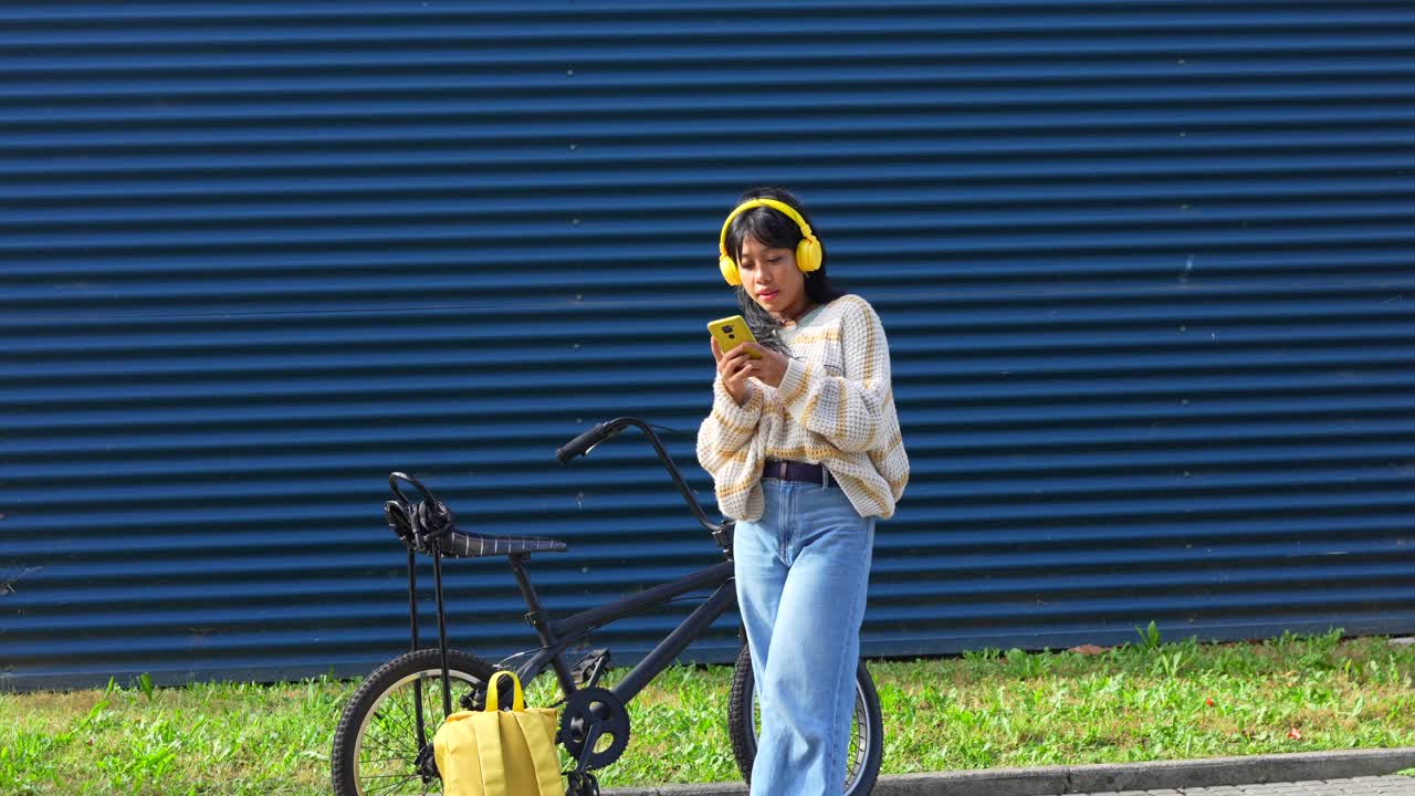 Woman with Bicycle and Yellow Handbag