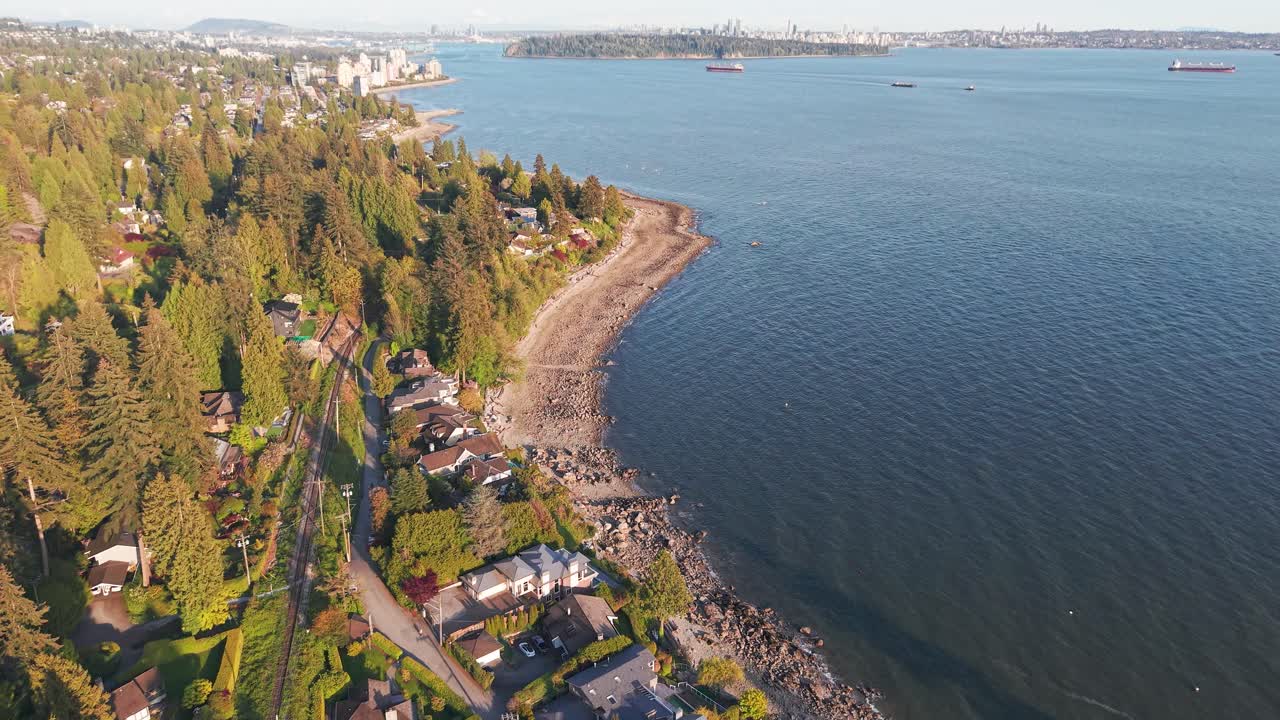 an aerial shot of luxury homes along the coastline of Proctor Avenue, West Vancouver with Vancouver City over the horizon
