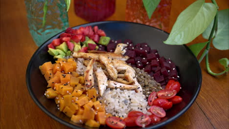 Dolly-in-shot-of-a-healthy-high-protein-bowl-with-sweet-potato-beet-lentils-rice-chicken-breast-and-tomatoes