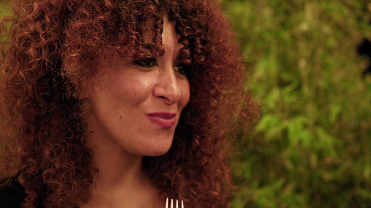 At The Restaurant A Woman Smiling After Eating Delicious Food With The Fork