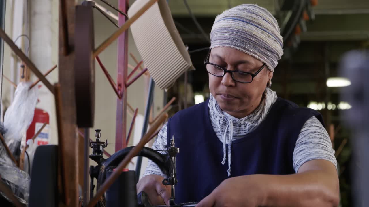 Mixed race woman working at a hat factory