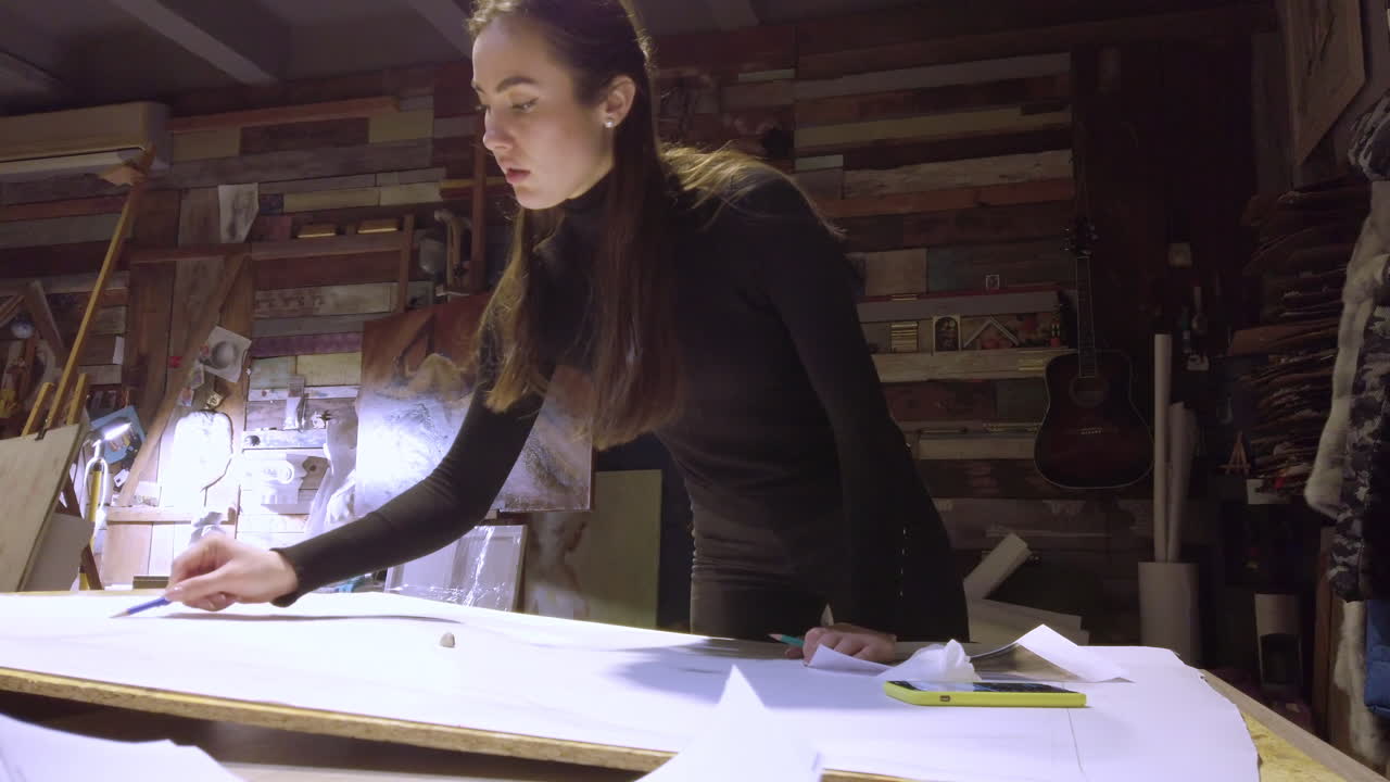 Woman sketching on a canvas at an art gallery workshop