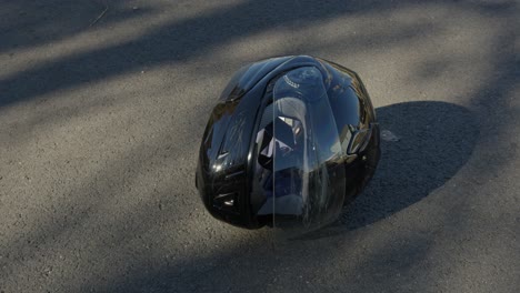 wide pan right of a damaged motorcycle helmet