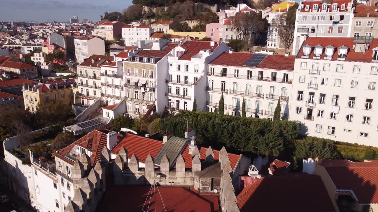 Drone flying backwards to real the belfry of the spectacular Catedral Sé Patriarcal Igreja de Santa Maria Maior in Alfama Lisbon Portugal in Winter on a sunny day