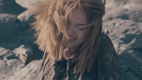 happy woman with short hair waved by strong wind slow motion