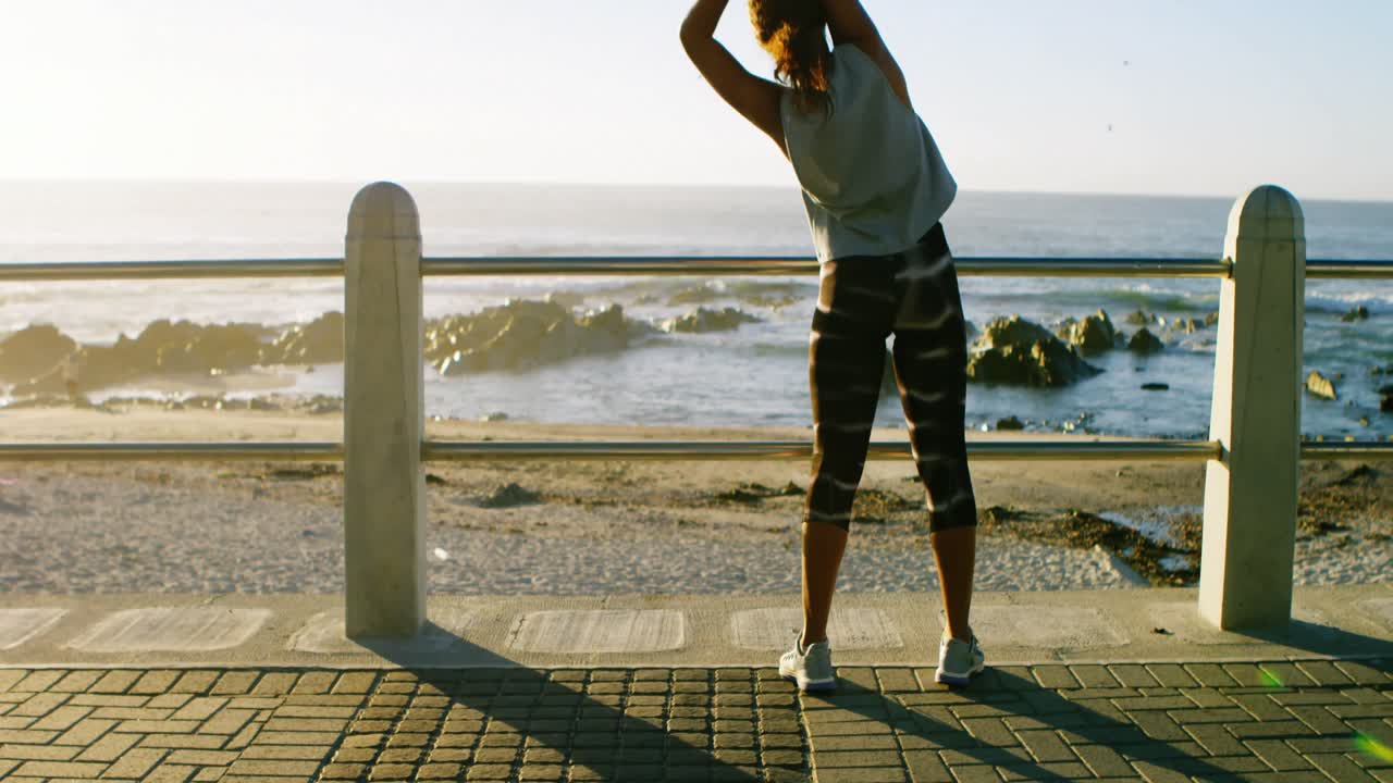 Woman exercising in the beach 4k
