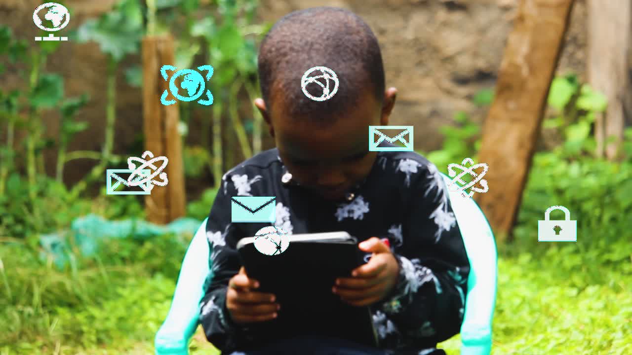 Male young african kid using tablet feeling happy and excited in a outside the Africa rural houses