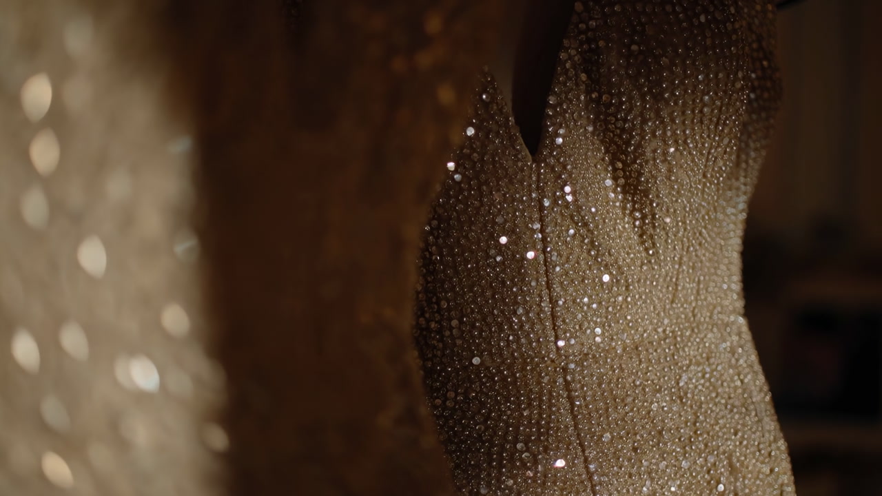 Glittering Sequin Gown In Warm Light, Closeup Of Intricate Beading And Crystal Embellishments On Couture