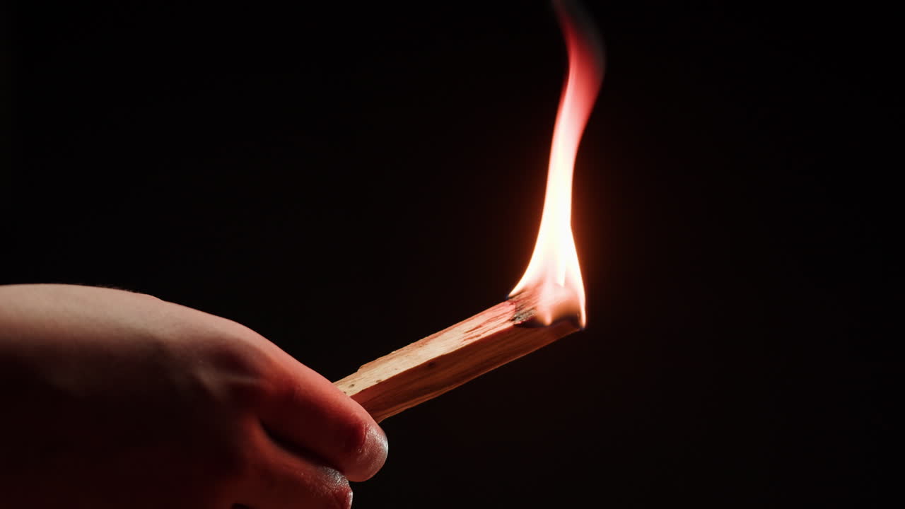 Hand Holding Burning Incense Stick