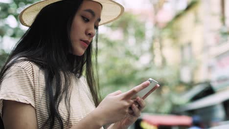 Handheld-view-of-focused-woman-using-mobile-phone