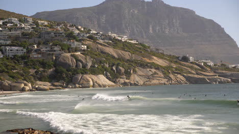 Surfers-riding-waves-in-Cape-Town-South-Africa-at-sunrise