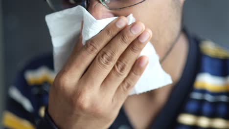 man blowing his nose