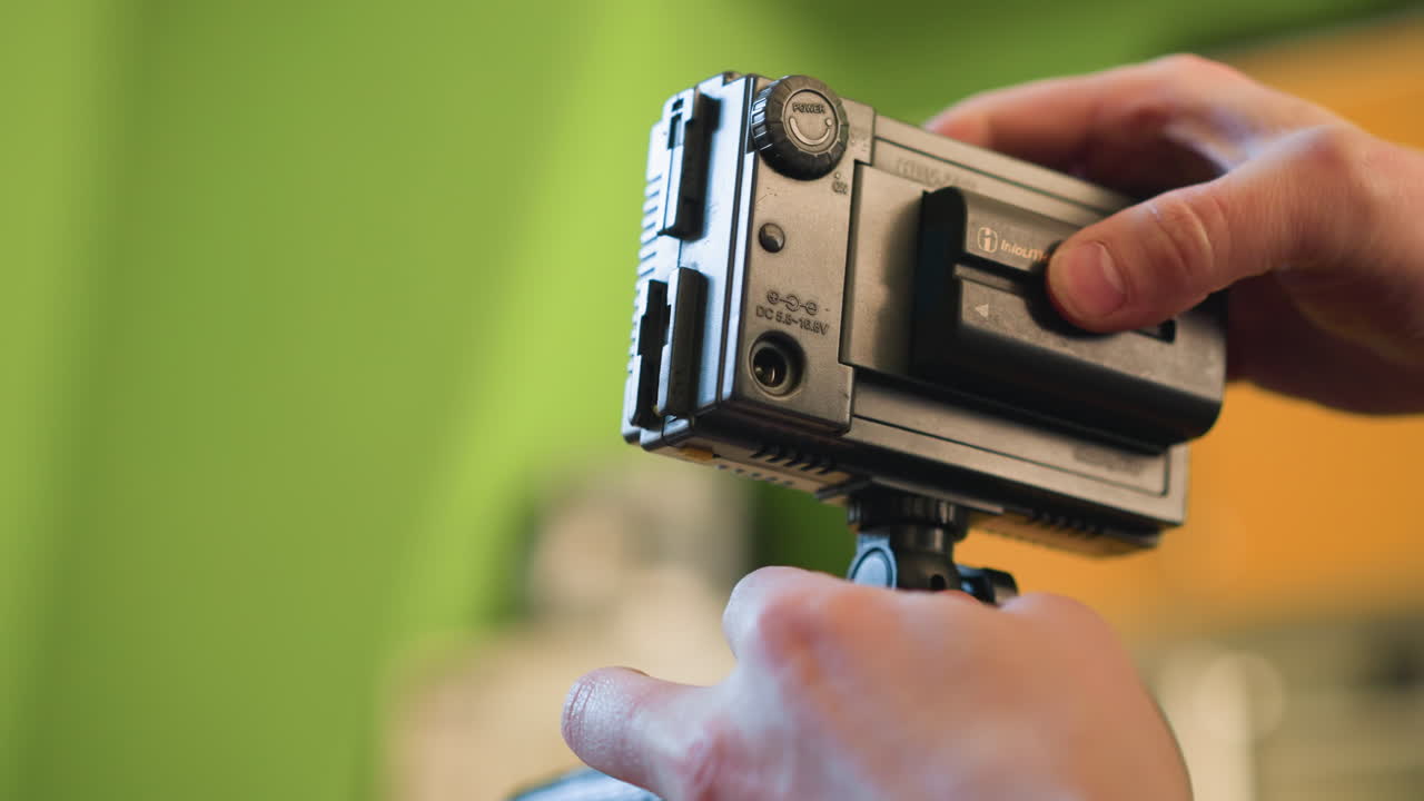 close-up of hands adjusting camera rig, mounting equipment for video production. preparing camera gear for filming. lighting operator setting up gear for professional video production shoot