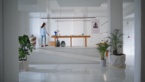 young woman walking store in art gallery. visitor looking exposition artworks