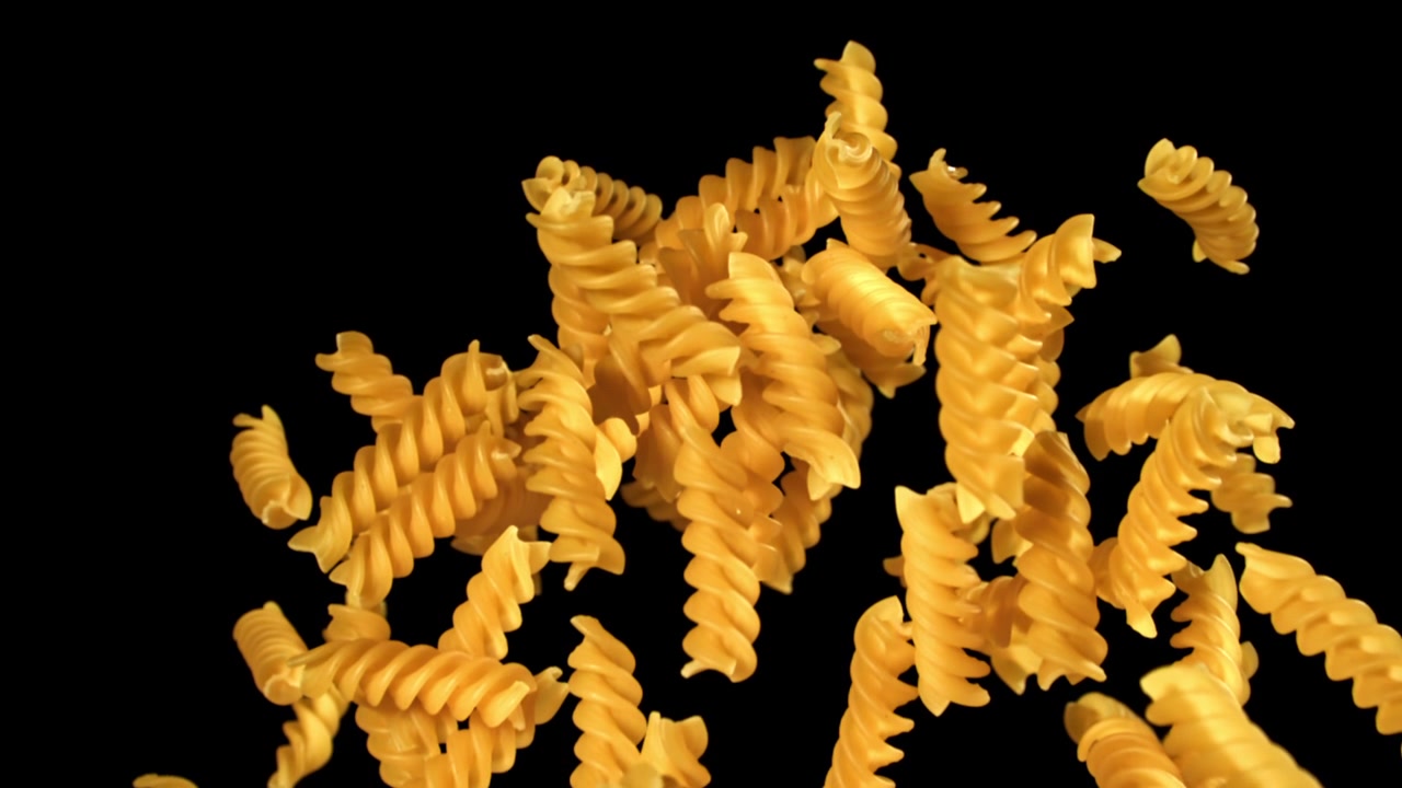 Slow Motion Shot of Fusilli Pasta Falling and Rising