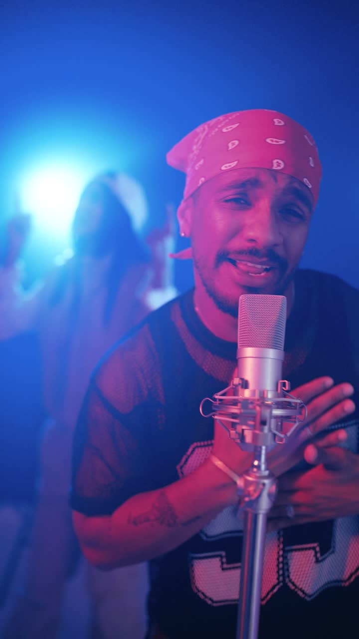 Reggaeton singer performing song in music video studio