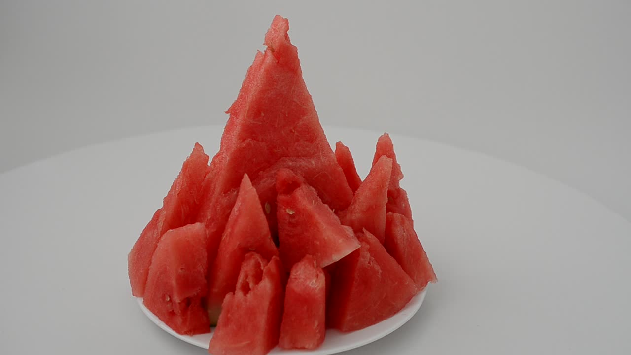 Shooting of a watermelon on a white background. Shooting in the movement