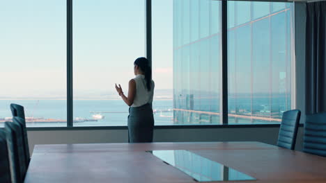 asian-business-woman-using-smartphone-corporate-sales-executive-chatting-to-client-financial-advisor-negotiating-deal-sharing-expert-advice-having-phone-call-in-office-looking-out-window