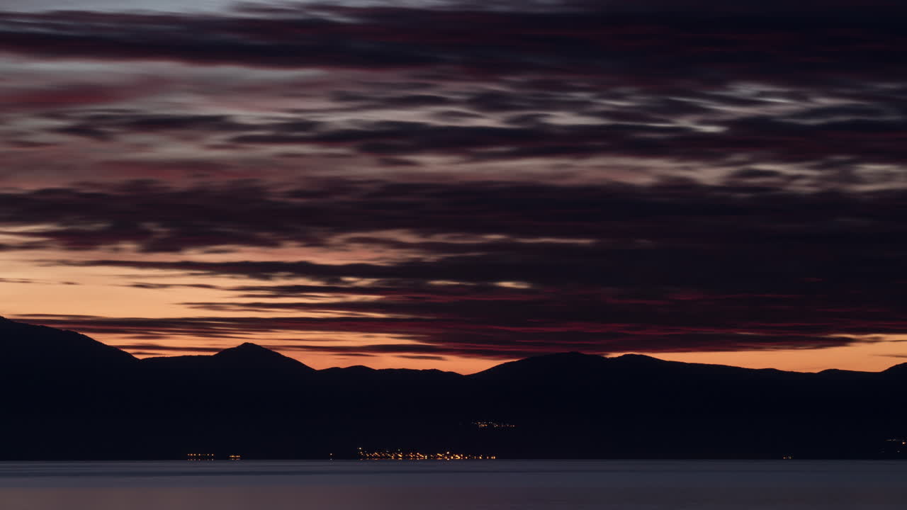 Timelapse of night coming to coastal town