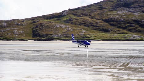 shot of a passenger plane taxiing along the beach after landing at barra airport