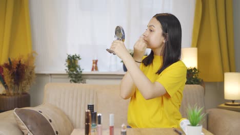 Young-woman-plucking-her-eyebrows-with-tweezers.-Facial-care.