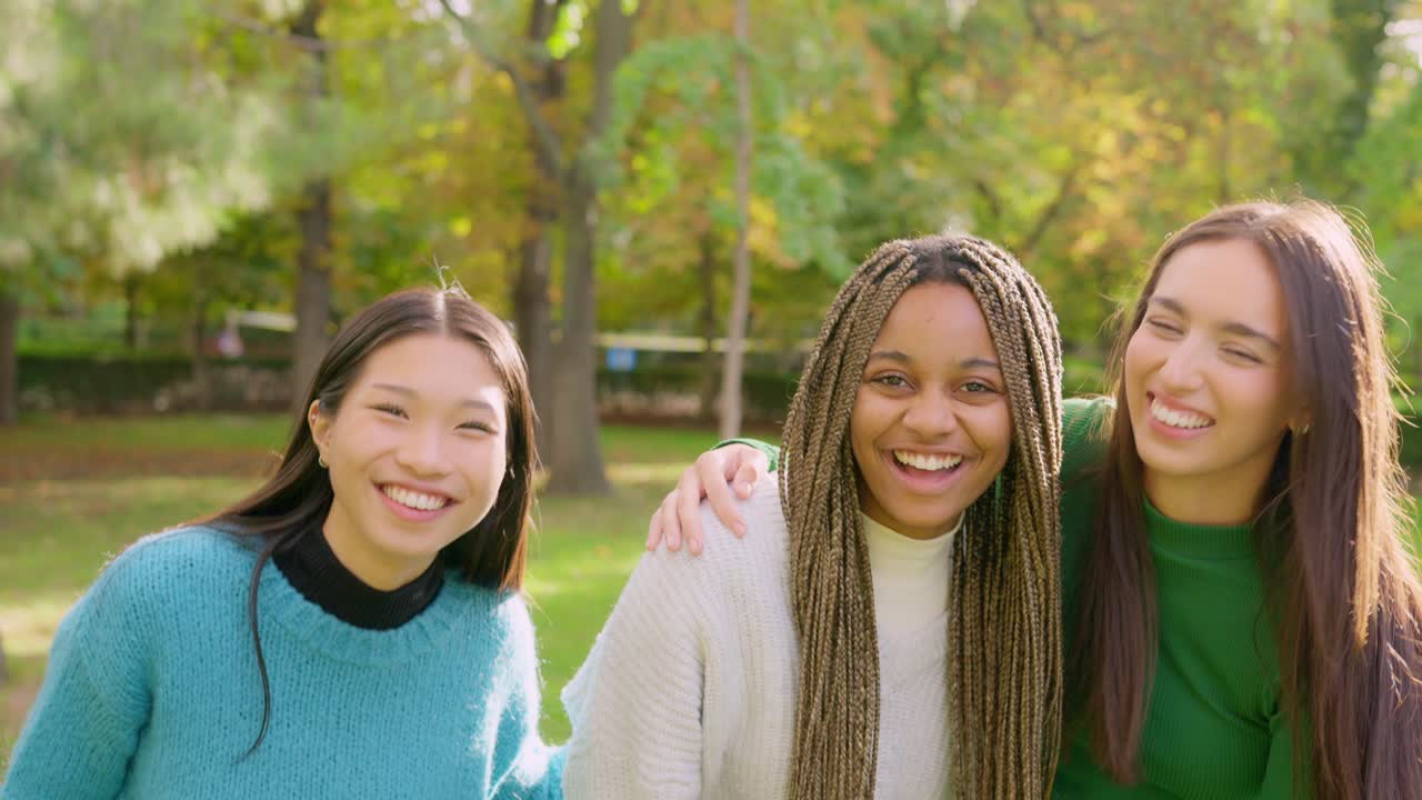 Happy Diverse Friends Embracing and Laughing in a Park