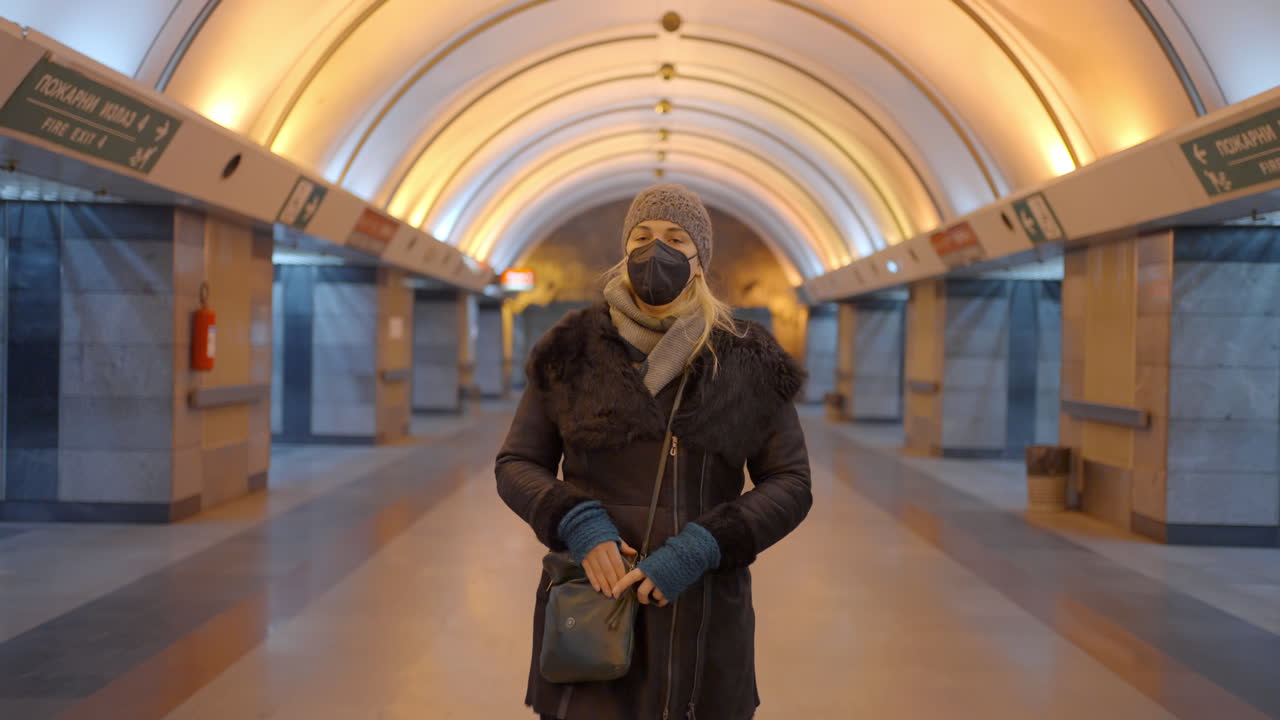 Woman wearing a mask in a subway tunnel
