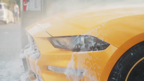 yellow car being washed at a car wash