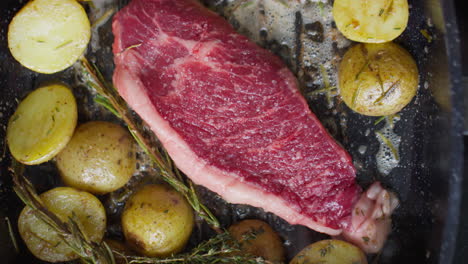 steak and potatoes being cooked on grill pan