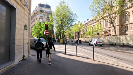 two people walking on a sunny street