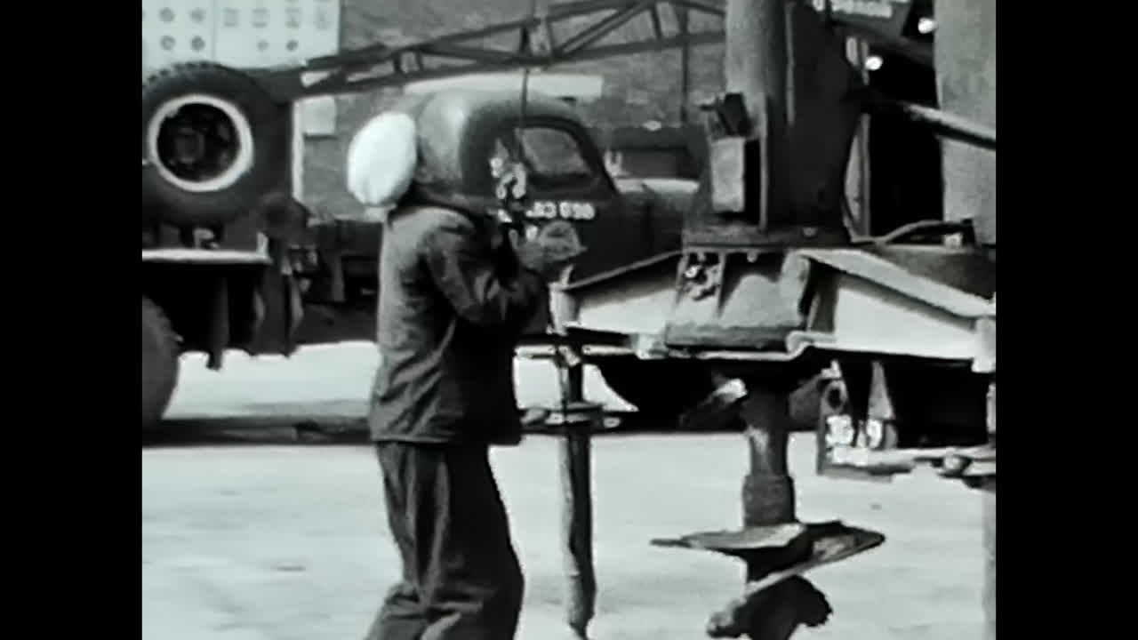 Man in Suit Holding Broom in the Soviet Union Archives. CIRCA USSR 1970: A man dressed in a suit holds a broom inside the Soviet Union Archives.