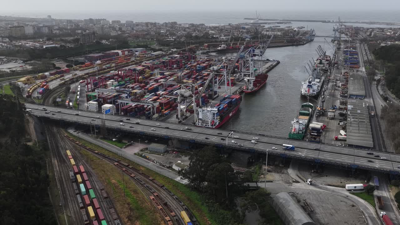 Porto shipping port with containers cranes and boats next to highway. Harbour in Portugal