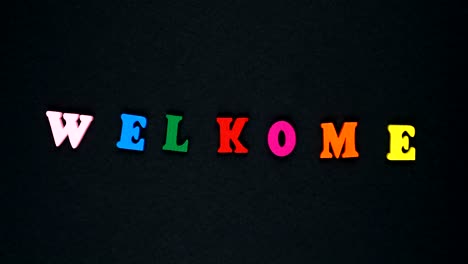 word "welcome" with mistake formed of wooden multicolored letters. colorful words loop.