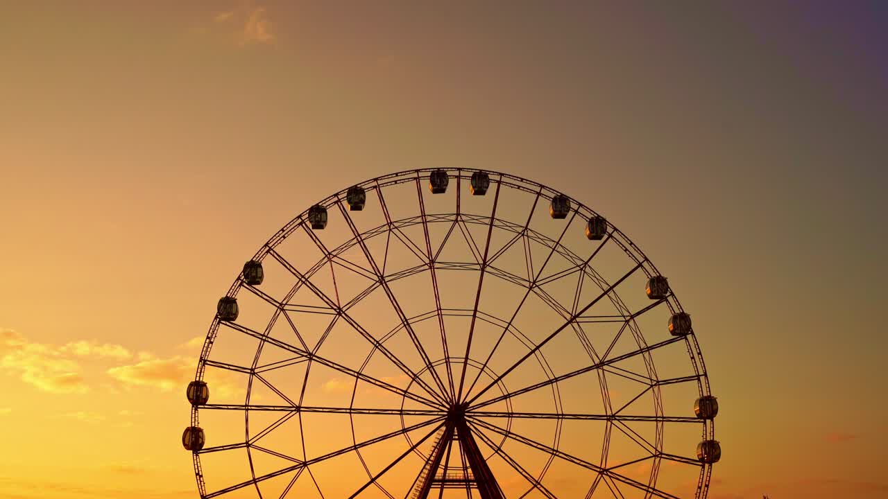 la rueda gigante contra un cielo al atardecer.