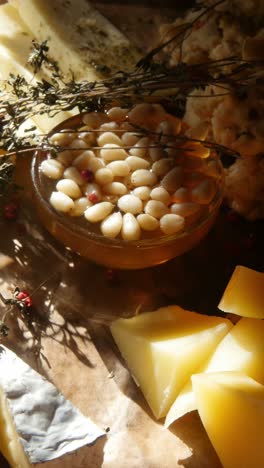 cheese and honey board with pine nuts