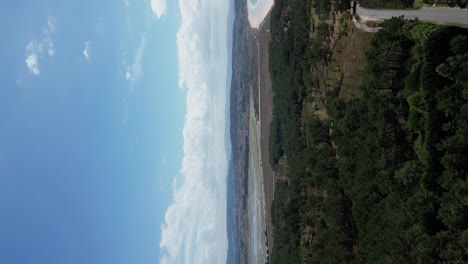 Vertical-video-of-Lanzada-beach-in-Sanxenxo-Coastline,-turquoise-water-bay,-Galicia,-Spain