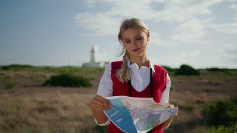 Involved-traveler-exploring-map-outdoor-closeup.-Vertical-lady-checking-route