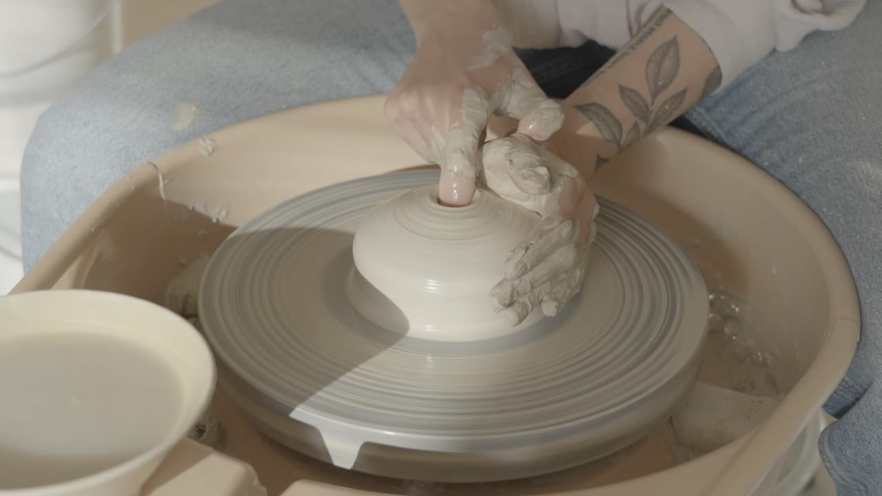 female potter working on the wheel