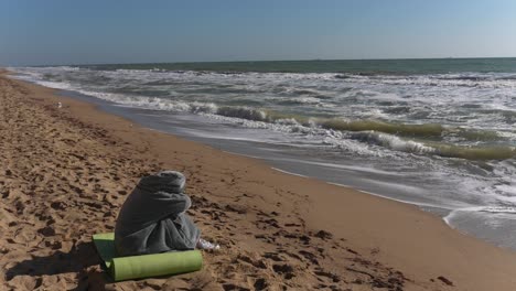 person sitting alone on a beach