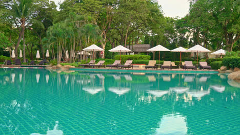 umbrella and chair around swimming pool in hotel resort - holiday and vacation concept