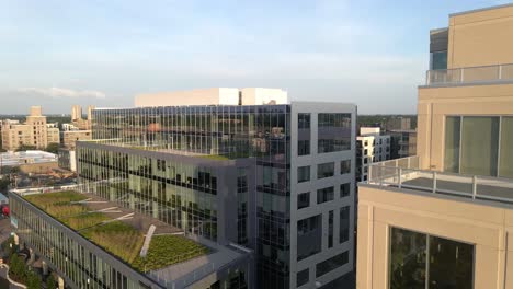 aerial view of a couple of buildings during golden hour, camera approaching to a 7 floor hight building