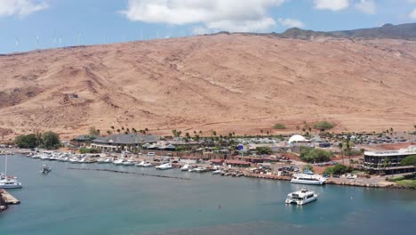 low aerial shot flying over maalaea harbor towards the maui ocean center in west maui, hawai'i