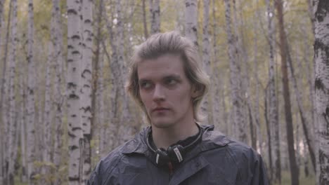 young man in a birch forest