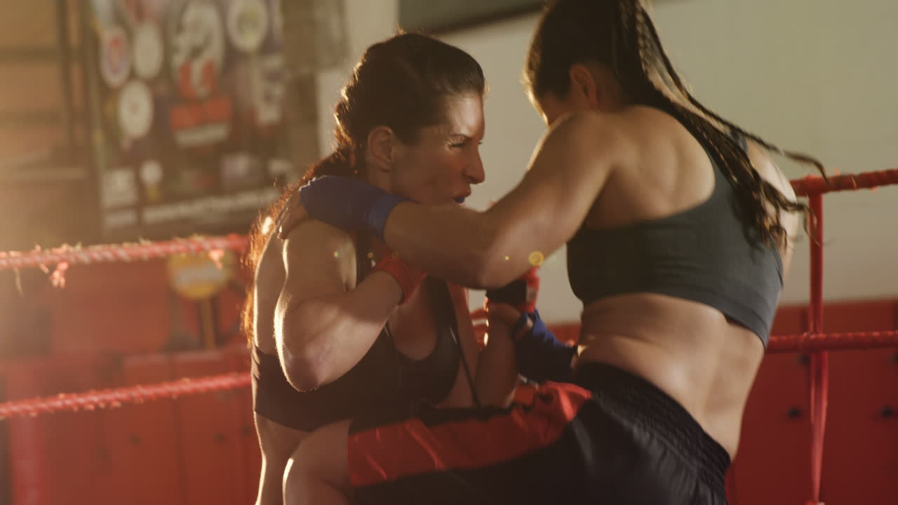 dos boxeadoras practicando en el ring de boxeo