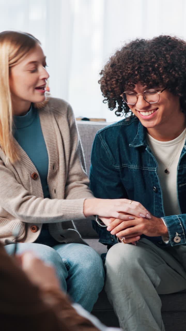 Young Woman Comforting Man by Holding His Hand