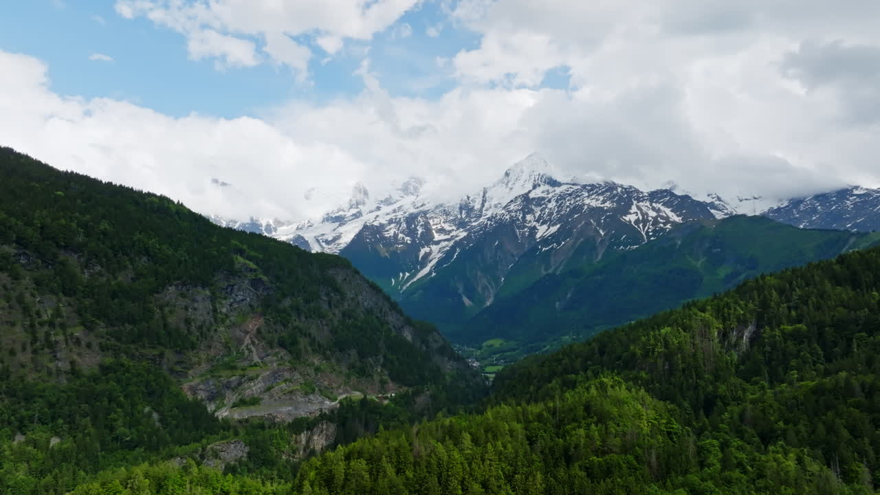 Aerial panorama shot of snow-capped Alpines of Chamonix, summer day in France